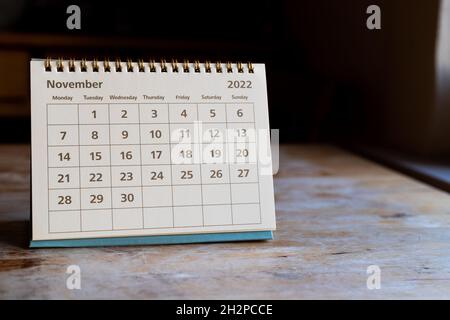Month page: November in 2022 paper calendar on the wooden table Stock Photo