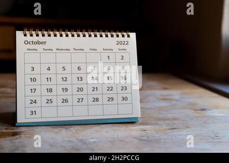 Month page: October in 2022 paper calendar on the wooden table Stock Photo