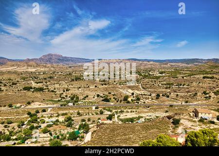 View from the hill to the Busot area and the Cabeco D'or mountain range. Beautiful sunny landscape with a blue sky.Horizontal view Stock Photo