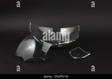Broken glass pieces on black background. Stock Photo