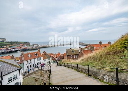 Whitby, Yorkshire, UK – October 18 2021. A view over Whitby town and harbour captured from the 199 steps to the Abby and St Mary’s Church Stock Photo