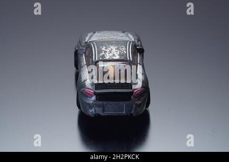 old retro scratched model toy sports car on the background Stock Photo