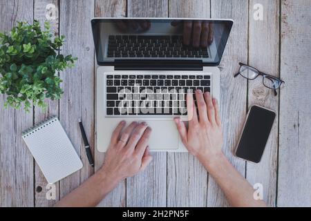 workplace top view, internet search online, using computer, hands typing on laptop from above Stock Photo