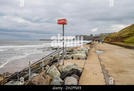 Steps sign identifying the stairway from Whitby promenade or esplanade to the sandy beach Stock Photo