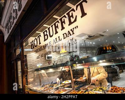 Chinese hot buffet selection 'eat as much as you like' window with diners patrons self selecting a variety of Chinese food Wardour Street Chinatown Soho London UK Stock Photo