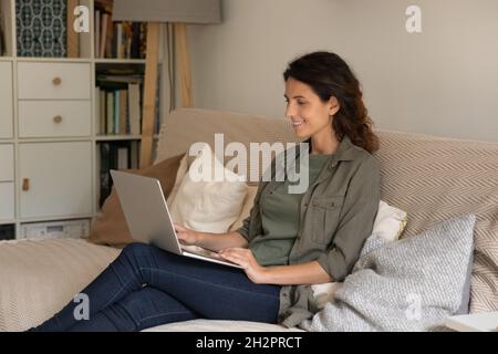 Happy female student, remote employee studying or working from home Stock Photo
