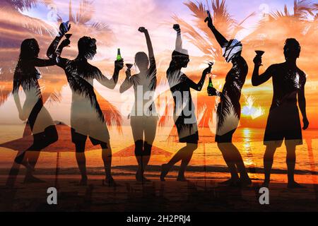 tropical beach party, group of young people dancing, friends drinking beer and cocktails at sunset Stock Photo
