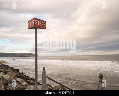 Steps sign identifying the stairway from Whitby promenade or esplanade to the sandy beach Stock Photo