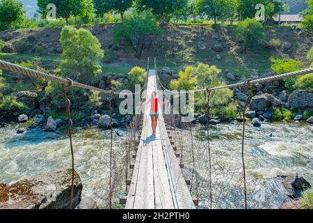 a girl stands in the middle of the underworld bridge in Georgia Stock Photo