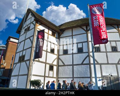 The Shakespeare Globe Theatre with visitors taking a break outside. London SouthBank South Bank River Thames England UK