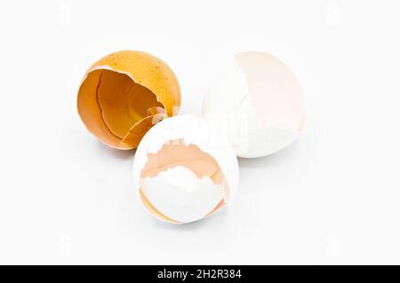 White and brown broken egg shells, cracked egg shells, isolated on white background Stock Photo