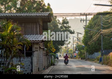 Motorbiker driving in the village of Khao Tao south of Hua Hin, Thailand