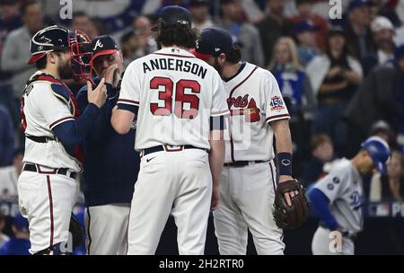 From left, Atlanta Braves catcher Tyler Flowers, left, shortstop Dansby  Swanson and relief pitcher Sean Newcomb gather on the mound after Newcomb  hit New York Mets' Robinson Cano with a pitch during