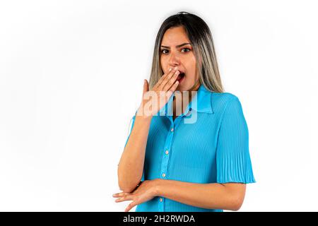 A Beautiful young woman with an expression of shame and with her hand covering her mouth. Stock Photo