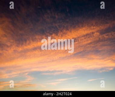 Colorful sunset sky with dramatic orange clouds. Only sky, no land. Stock Photo