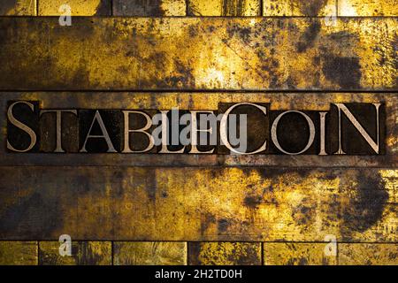 Stablecoin text message on textured grunge copper and vintage gold background Stock Photo