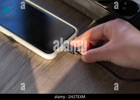 Magnetic cable for charging smartphone, close up. Stock Photo