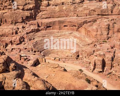 The Nabatean amphitheatre in the ancient city of Petra, Jordan. Theatre with row of seats and stairways carved into the side of the mountain. Stock Photo