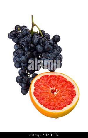 Dark blue grape with red grapefruit isolated on white background Stock Photo