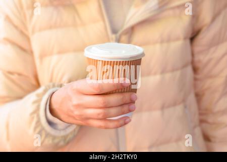 Close-up of woman holding eco-friendly cup of coffee to go, street coffee, zero waste Stock Photo