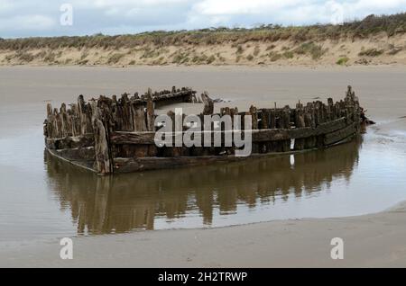 Remains of old wooden boat shipwreck on Cefn Sidan beach Pembrey Country Park Llanelli Carmarthenshire Wales UK Stock Photo