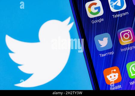 The icon of the Twitter social network application among other applications on the smartphone screen. On the background Stock Photo