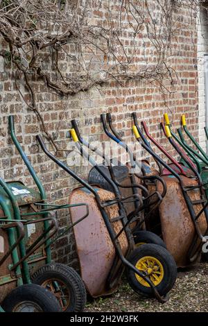 Line of wheelbarrows in large garden Stock Photo