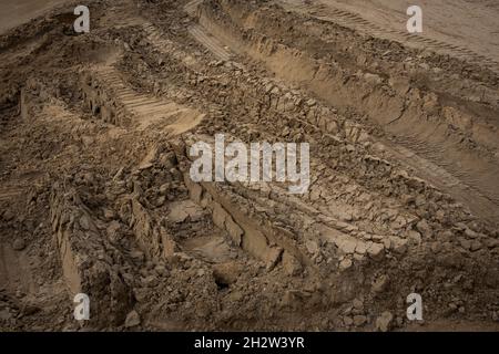 Wheel trail on sandy ground from large transport, tractor, sandy road Stock Photo