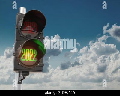 Traffic light with green light 2022 and red 2021 on sky background. Start New 2022 Year concept. 3d illustration