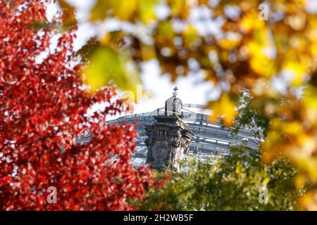 The Reichstag Dome is seen behind red, green and yellow leaves in Berlin, Germany, October 24, 2021. REUTERS/Michele Tantussi