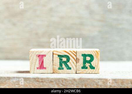 Alphabet letter block in word IRR (Abbreviation of internal rate of return) on wood background Stock Photo