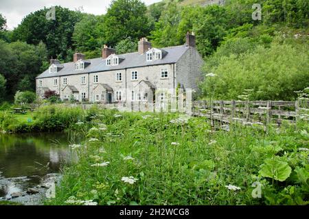 Blackwell Mill cottages on the River Wye, Upper Wye Valley near Buxton, Peak District, Derbyshire, England, UK. Stock Photo