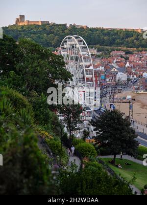 The Big wheel and distant Scarborough Castle above Scarborough seaside resort town on the North Sea coast of North Yorkshire, England. Stock Photo