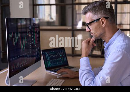 Crypto trader investor using computer cryptocurrency stock market trading chart. Stock Photo