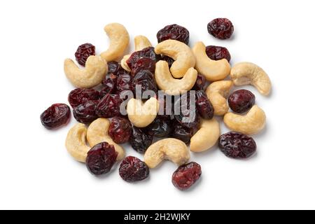 Heap of Cashew nuts and cranberries isolated on white background close up Stock Photo