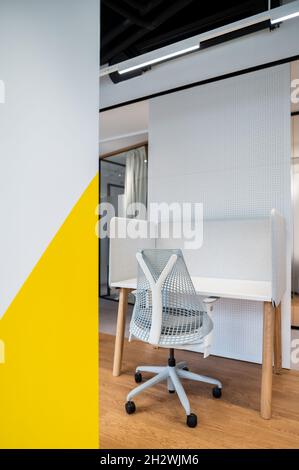 Comfortable office chair near table with modern computer. Stylish workplace with computer at office Stock Photo