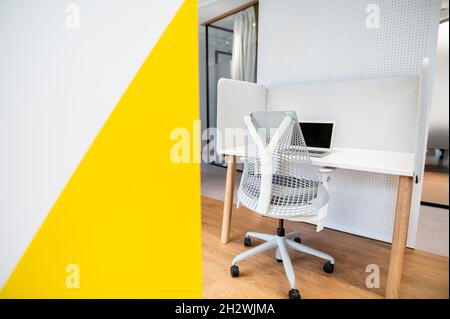 Comfortable office chair near table with modern computer. Stylish workplace with computer at office Stock Photo