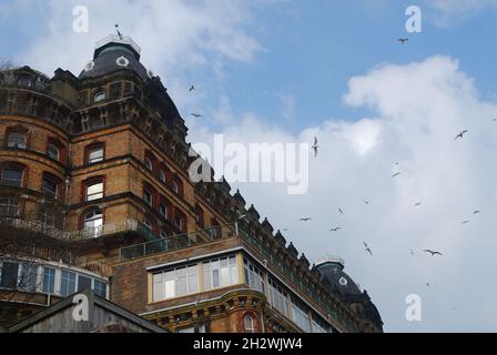 Looking up at the Grand Hotel in Scarborough, with birds wheeling in the sky Stock Photo
