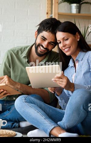 Close up portrait of an attractive married couple using digital tablet. Technology, people concept Stock Photo