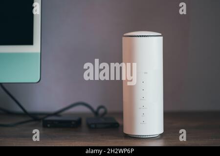 5G wireless router on desk Stock Photo