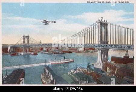 Antique postcard entitled “Manhattan Bridge, New York City”. Published in 1910, this postcard depicts an early biplane flying over the newly constructed Manhattan Bridge as a ship passes beneath. Stock Photo