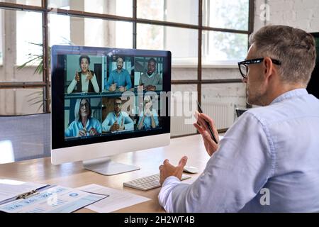 Corporate manager leading videoconference with team business people on computer. Stock Photo