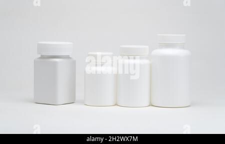 White plastic pill jars on a white background. Isolated Stock Photo