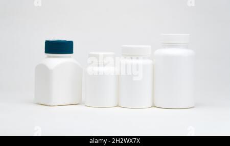 White plastic pill jars on a white background. Isolated Stock Photo
