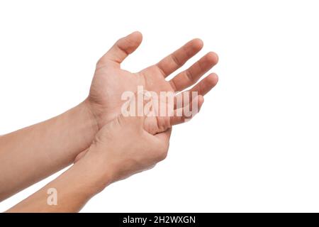 Unrecognizable millennial caucasian guy suffering from pain in arm, presses hand to sore spot, holding her wrist Stock Photo