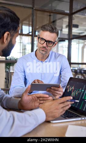 Two traders brokers stock exchange market investors discussing crypto trading. Stock Photo