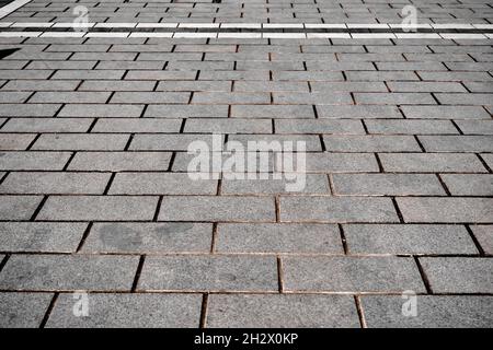 Modern tile and cobblestone way, paving stone and white street lines near city park for pedestrians way made of concrete stone ground floor outside Stock Photo