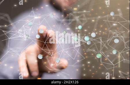 A male's hand pointing to illustrated digital network and data concept Stock Photo