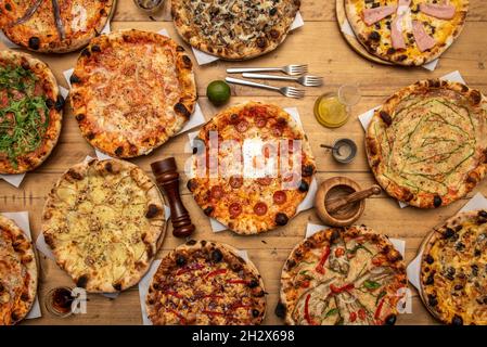 Assorted pizza with bell peppers, mozzarella cheese, sirloin, aubergines, zucchini slices, pepperoni, raw onion, bologna mortadella, fried eggs and be Stock Photo