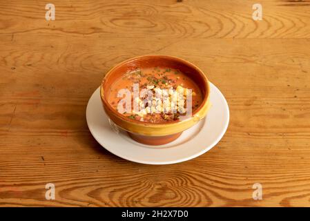 Delicious cold Andalusian gazpacho soup with tomato, garlic, onion, vinegar and oil, boiled eggs, sliced cucumbers, Iberian ham and peppers Stock Photo